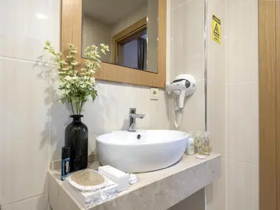 a bathroom with a white sink and a mirror at Merlin Hotel İstanbul in Istanbul