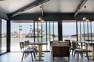 a restaurant with tables and chairs and a view of the city at Mest Hotel Istanbul Sirkeci in Istanbul