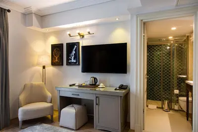 a bathroom with a desk and a television on a wall at Mest Hotel Istanbul Sirkeci in Istanbul