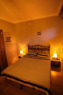 a bedroom with a large bed with two lamps at Bahçeli Concept Sapanca in Sapanca