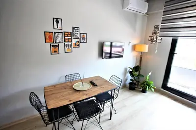 a dining room with a wooden table and chairs at Bahçeli Concept Sapanca in Sapanca