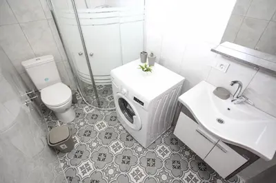 a white bathroom with a toilet and a sink at Bahçeli Concept Sapanca in Sapanca