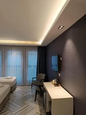 a hotel room with two beds and a tv at Sel Suite Hotel in Istanbul