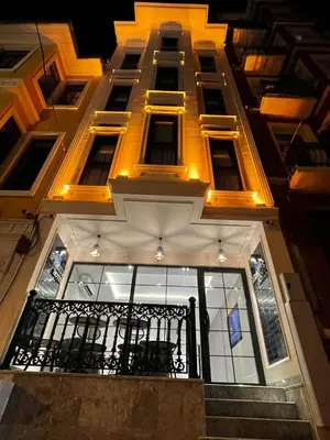 a lit up building with a balcony and stairs at Sel Suite Hotel in Istanbul