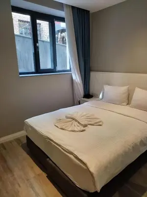 a bedroom with a bed with a robe on it at Sel Suite Hotel in Istanbul