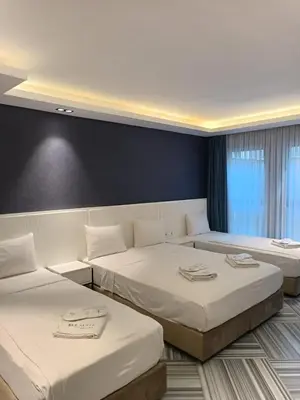 a hotel room with three beds in it at Sel Suite Hotel in Istanbul