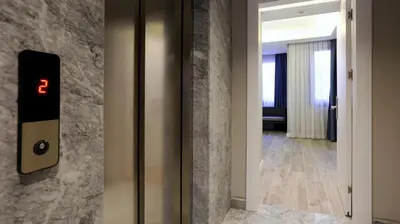 a elevator with a clock on the wall at Sel Suite Hotel in Istanbul