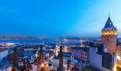a view of a city with a clock tower at night at Meroddi Barnathan Hotel in Istanbul