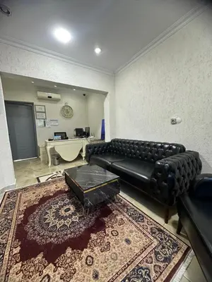 a living room with a black leather couch and a rug at Big Orange Hotel Old City in Istanbul