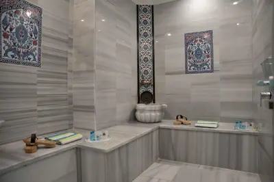 a bathroom with a shower with two sinks and shoes at Big Orange Hotel Old City in Istanbul