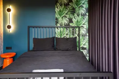 a bedroom with a bed with a tropical wallpaper at Sapanca Glamping in Sakarya