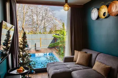 a living room with a couch and a large window at Sapanca Glamping in Sakarya