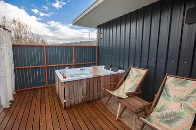 a hot tub and two chairs on a deck at Sapanca Glamping in Sakarya