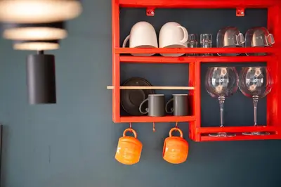 a red cabinet with plates and wine glasses on it at Sapanca Glamping in Sakarya