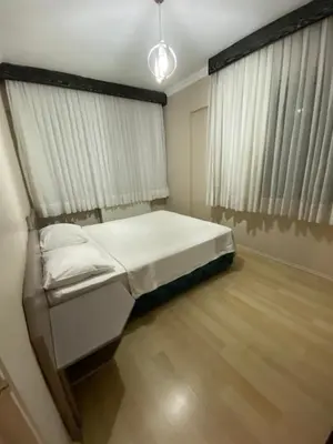 a small bedroom with a bed and a window at EVİM APART HOTEL in Termal