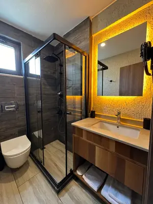 a bathroom with a shower and a sink and a toilet at Villa Siesta Hotel Istanbul Airport in Karaburun
