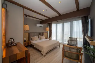 a bedroom with a bed and a large window at Villa Siesta Hotel Istanbul Airport in Karaburun