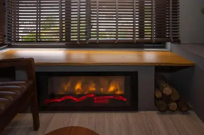 a fireplace in a living room with a bench above it at Villa Siesta Hotel Istanbul Airport in Karaburun