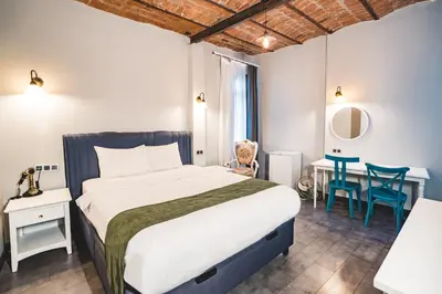 a bedroom with a bed and a table and chairs at Hotel Fresia Istanbul in Istanbul