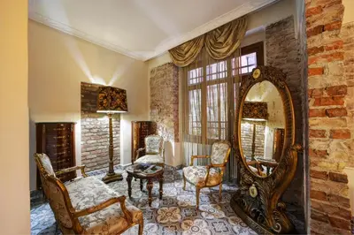 a living room with a large mirror and chairs at Hotel Fresia Istanbul in Istanbul
