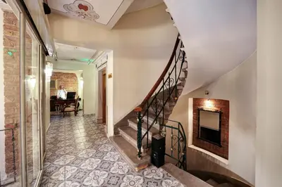 a hallway with a spiral staircase with a fireplace at Hotel Fresia Istanbul in Istanbul