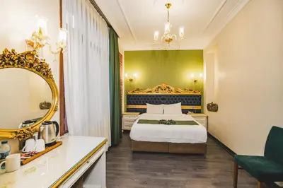a hotel room with a bed and a mirror at Hotel Fresia Istanbul in Istanbul
