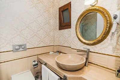 a bathroom with a bowl sink and a mirror at Hotel Fresia Istanbul in Istanbul