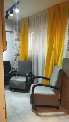 a living room with two chairs and curtains at Gafa Garden Hostel & Apartments - Great Location in Istanbul