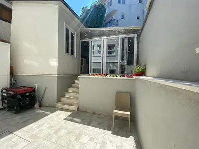 a house with a chair and a stair case at White Island Boutique Otel in Adalar