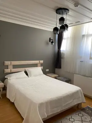 a bedroom with a large white bed and a window at White Island Boutique Otel in Adalar