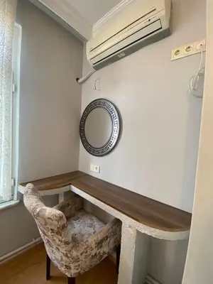 a room with a desk and a mirror and a chair at RAMO’S Aparatments & Suites in Istanbul