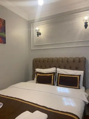a bedroom with a large bed with two pillows at RAMO’S Aparatments & Suites in Istanbul