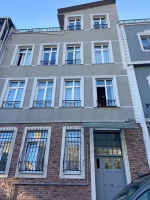 a tall brick building with windows and a door at RAMO’S Aparatments & Suites in Istanbul