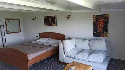 a bedroom with a bed and a couch at Gölyaka Hotel in Bursa