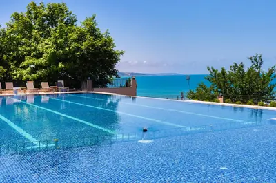 a large swimming pool with a view of the water at The Sign Degirmen Hotel&Spa Wellness in Istanbul