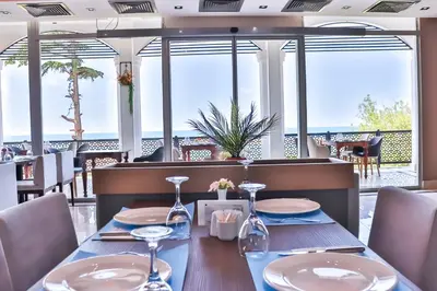 a dining room with a table with a view of the ocean at The Sign Degirmen Hotel&Spa Wellness in Istanbul