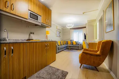 a kitchen with a sink and a living room at La Palace Exclusive Design in Istanbul
