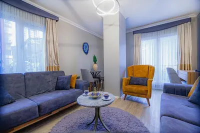 a living room with a blue couch and a table at La Palace Exclusive Design in Istanbul