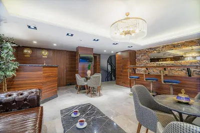 a lobby with a bar and a table and chairs at La Palace Exclusive Design in Istanbul