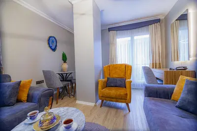 a living room with two blue couches and a table at La Palace Exclusive Design in Istanbul