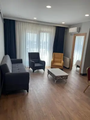 a living room with a couch and two chairs and a table at Almin Apart Hotel in Istanbul