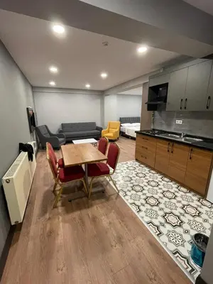 a kitchen and living room with a table and chairs at Almin Apart Hotel in Istanbul