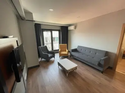 a living room with a couch and a tv at Almin Apart Hotel in Istanbul