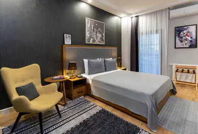 a hotel room with a bed and a chair at SALA SUITES in Istanbul