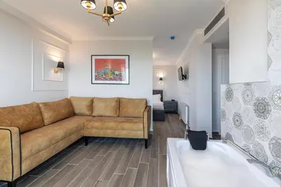 a living room with a couch and a tub at LAGUN CASTLE HOTEL&SPA in Yalova