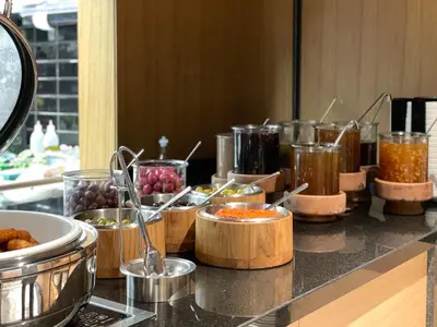a buffet line with various food items on a counter at Four Points by Sheraton Istanbul Kagithane in Istanbul