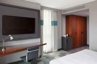 a hotel room with a flat screen tv and a bed at Four Points by Sheraton Istanbul Kagithane in Istanbul