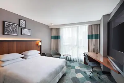 a hotel room with a bed and a desk and a television at Four Points by Sheraton Istanbul Kagithane in Istanbul