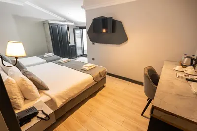 a bedroom with a bed and a tv on the wall at Express Plus Hotel in Istanbul