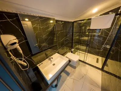 a bathroom with a sink and a shower and a toilet at Express Plus Hotel in Istanbul